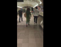 Woman walks at subway and wear leaves outfit design 