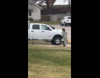 Woman green dress with handbag on driveway