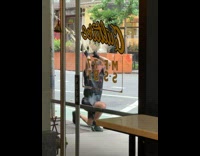 Guy does trx workout outside cafe