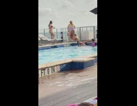 Three women bikini poolside man imitates them