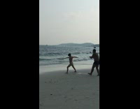 Woman blue bikini sideward arms beach waves