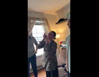 Woman playing harmonica at party