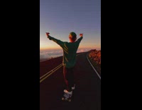 Man Skates Downhill on a Mountaintop Road