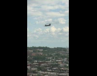 Chinook helicopter flies above the city buildings