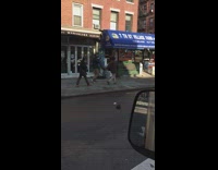 Two guys walk fast and carry a man 