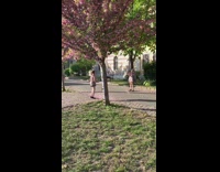 Girl floral dress jump shot tree park