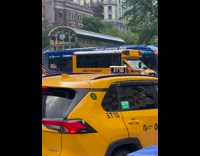 Guy eating hotdog at hotdog stall while guy films him