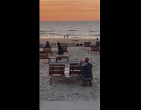 Woman sits on beach chair for photoshoot