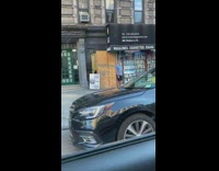 Blue shirt guy holds hand palm out 