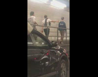 three people walking in highway tunnel