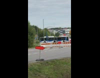 Two bus blocks the road with a road barrier