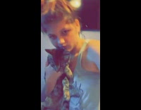 Woman zooms in on cat shes holding 