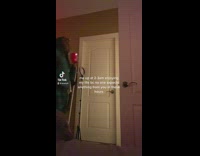 Guy walking through house red cup at night