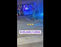 Woman dancing in front of police car 