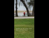Lady poses for photo by lake 