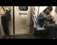 nsfw man handling his weed on subway train