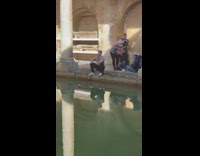Guy sits by fountain for photo