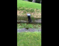 Guy jumps over creek and hits ground