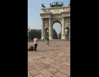 Woman hold bag walk spin Milano arch