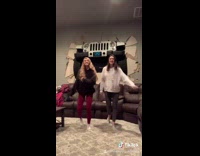 Two girls dancing in living with jeep through wall poster