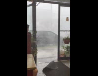 Strong rain and high winds outside restaurant