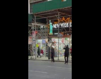 Subway rat mascot hangs on scaffold