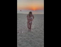 Woman in dress changes to bikini under