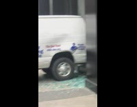 Car breaks store window 