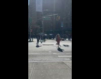 Woman runs across street guy records
