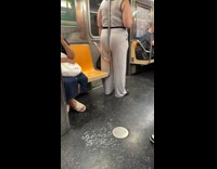 Woman stands on train lean on handrail