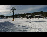 Guy attempts flip on snowboard hits ground