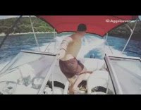 Guy jumps off moving white boat lake 