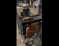 Steak grilled on shopping cart street night