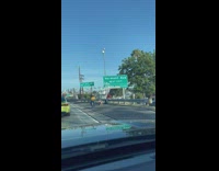 Two women poses in front of the road signage