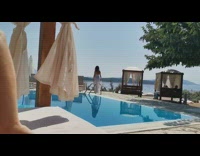 White bikini skirt girl walks by pool