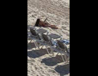 Woman lays and twerks on sand 