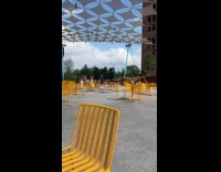 Group dancing at park being filmed by cameraman