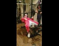 Red bathrobe guy lifts weight shotguns beer 