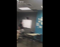 Guy student writes thot on whiteboard 