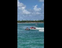 Woman in a bikini selfie while on a jet ski at the beach