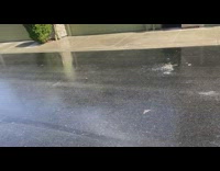 Falling snow creates steam over sunny neighborhood street