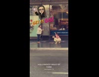 Woman white pants photo shoot Disney walk of fame