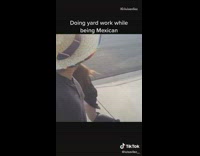 Doing yard work while being mexican sombrero 