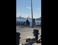 Guy pedals locked rental bicycle river water 