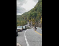 Two girls skirt walk clap mountain road