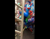 Vendor cart filled with balloons toys subway 