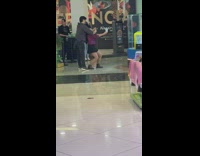 Woman holds their drink and man takes picture