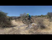 Girl drops down ramp on skateboard and falls