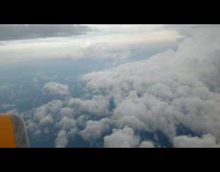 Filmer on plane shows view of clouds