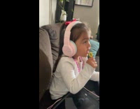 Kid on Headphones Sings Along with Music
